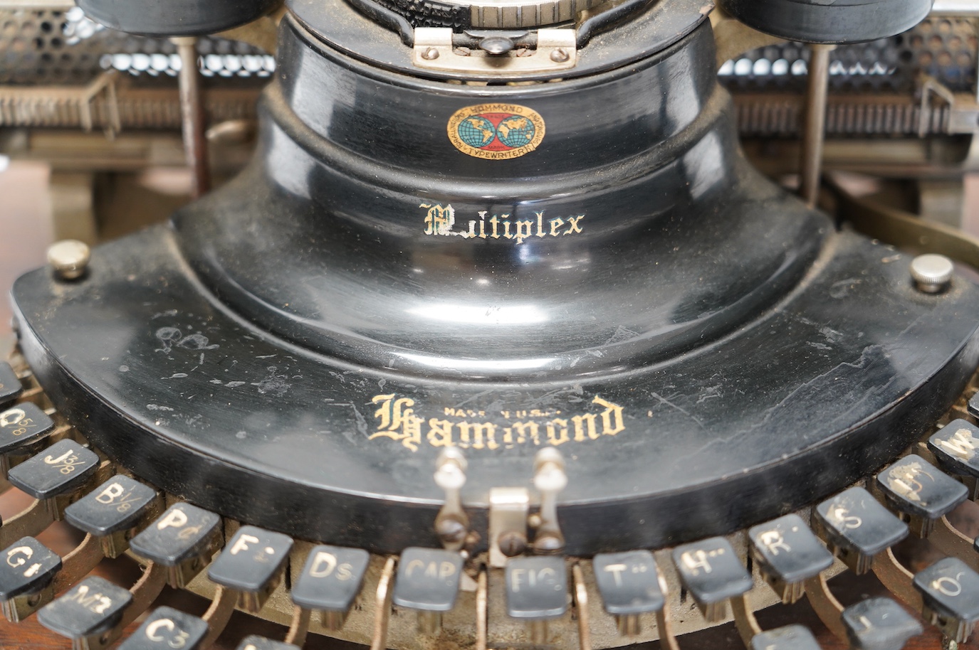 A scarce early 20th century Hammond Multiplex typewriter, with convex keyboard in an oak plywood case, case 20cm high, 35cm wide, 33cm deep. Condition - poor to fair, two keys missing and others worn or broken